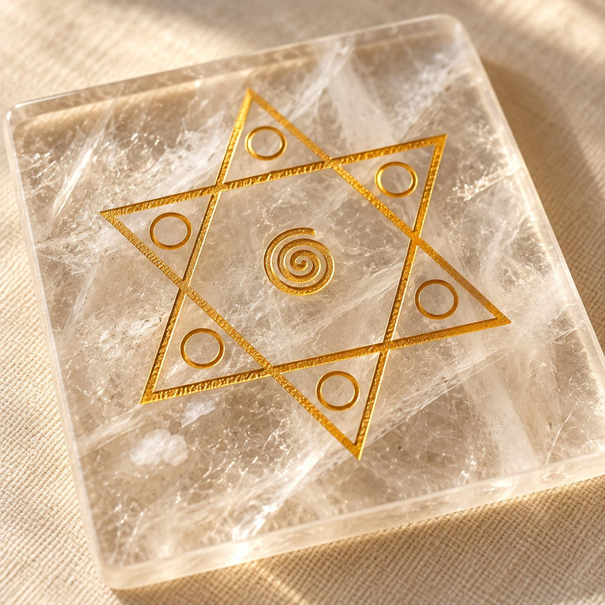 Close-up of the gold Shiv Shakti star engraving and natural veils in the sphatik plate